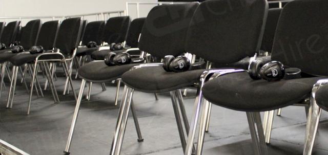 Furniture for Pop Up Cinema https://d1hcs5uofxldvl.cloudfront.net/chair-hire/article_additional/pop-up-cinema4/pop-up-cinema4-740x350.jpg - Headphones on every seat for all visitors to enjoy the film.