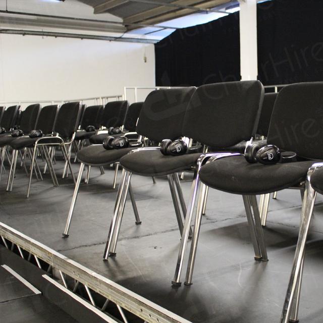Furniture for Pop Up Cinema https://d1hcs5uofxldvl.cloudfront.net/chair-hire/article_additional/pop-up-cinema4/pop-up-cinema4.jpg - Headphones on every seat for all visitors to enjoy the film.