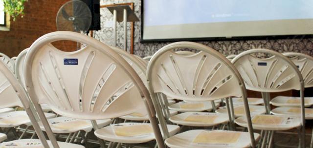 Presentation In The City https://d1hcs5uofxldvl.cloudfront.net/chair-hire/article_additional/presentation-in-the-city4/presentation-in-the-city4-740x350.jpg - Folding chairs complementing a modern location.