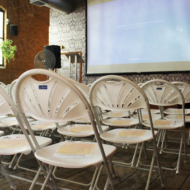 Presentation In The City https://d1hcs5uofxldvl.cloudfront.net/chair-hire/article_additional/presentation-in-the-city4/presentation-in-the-city4.jpg - Folding chairs complementing a modern location.