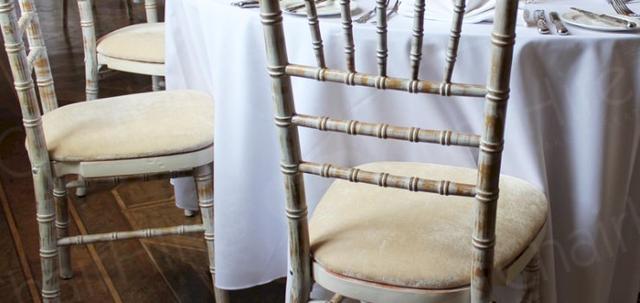 Furniture Hire for Weddings https://mill-media.s3.eu-west-2.amazonaws.com/chair-hire/article_additional/weddings-at-universities2/weddings-at-universities2-740x350.jpg - Limewash Chiavaris with cream pads for total elegance.