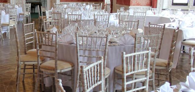Furniture Hire for Weddings https://mill-media.s3.eu-west-2.amazonaws.com/chair-hire/article_additional/weddings-at-universities6/weddings-at-universities6-740x350.jpg - Round trestle tables and Chiavaris add to the luxurious ambiance.