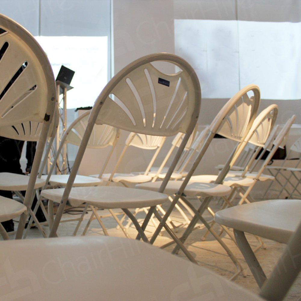 Folding chairs turn empty rooms into meeting areas.