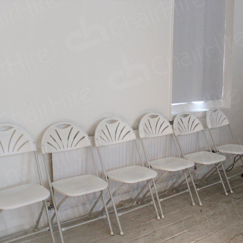 Folding chairs complement minimalist meeting rooms.
