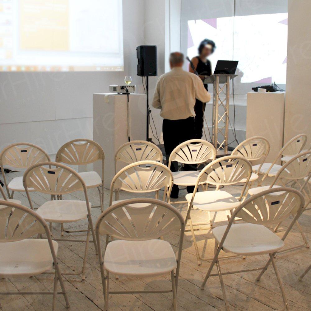 Modern white folding chairs for London events.