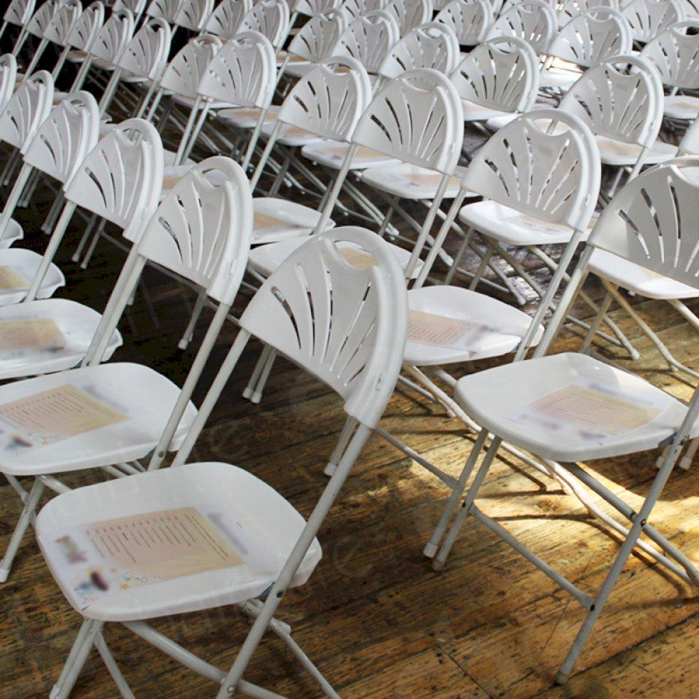White fan backs set up for city event.