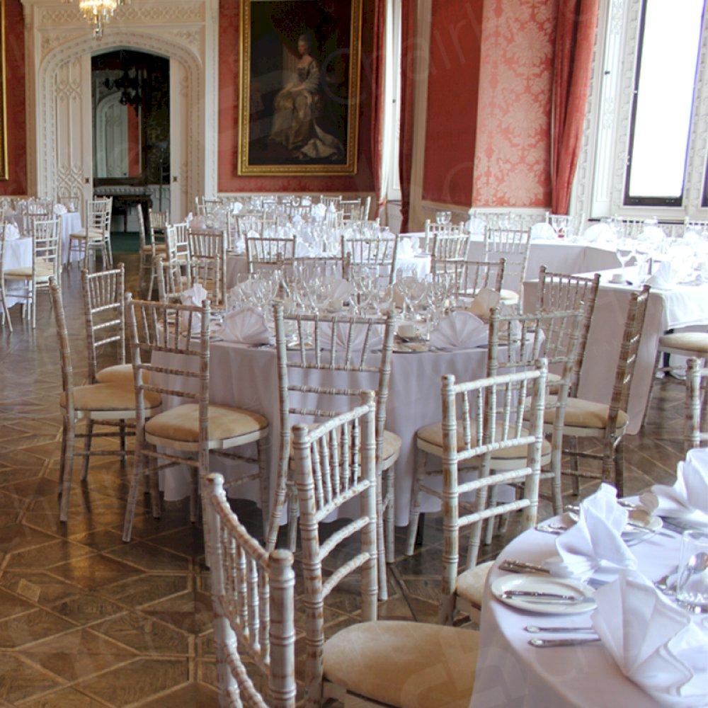 Round trestle tables and Chiavaris add to the luxurious ambiance.